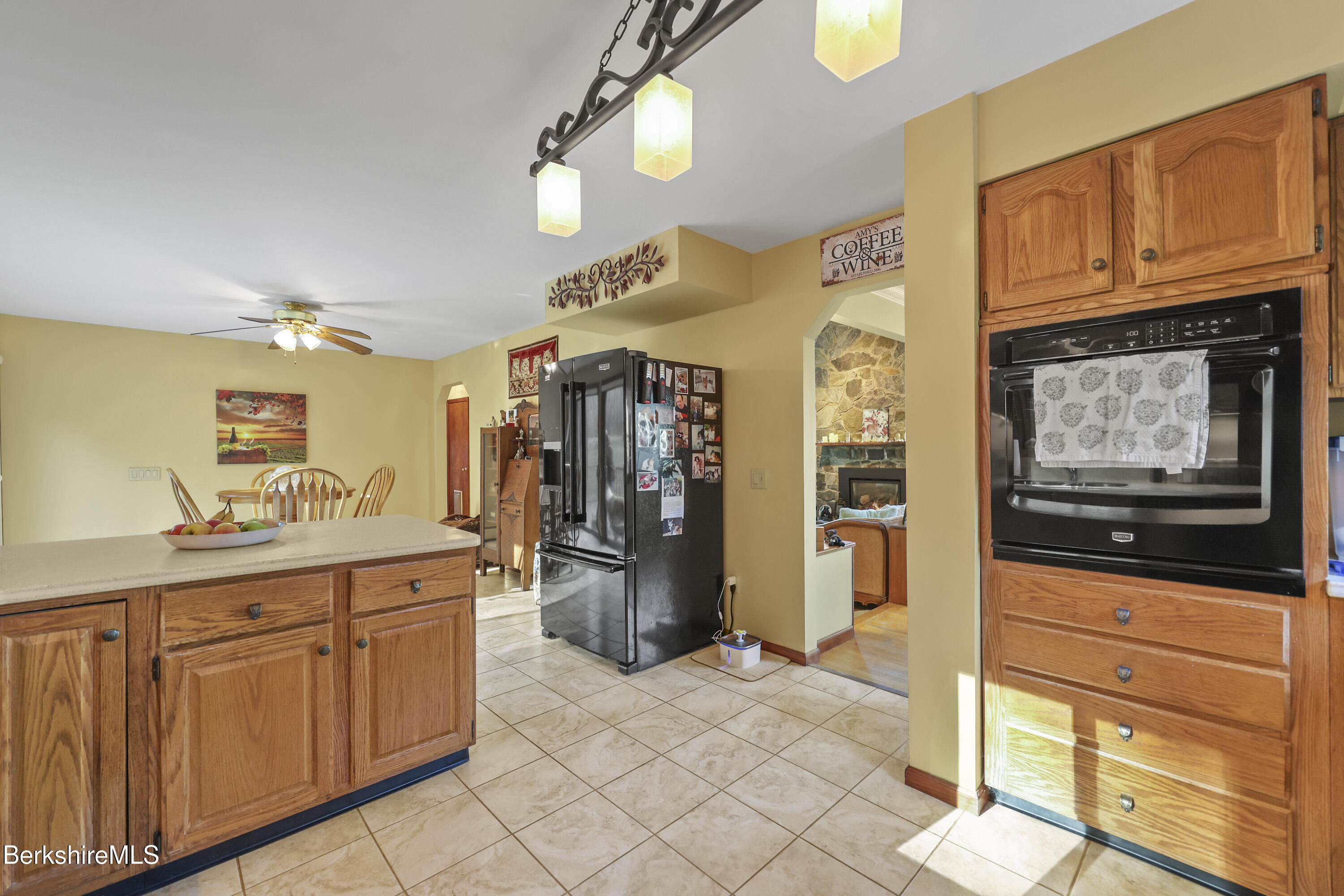 551 Tamarack Road Pittsfield, MA 01201 - Photo 20 of 51 a kitchen with stainless steel appliances kitchen island granite countertop a refrigerator and cabinets