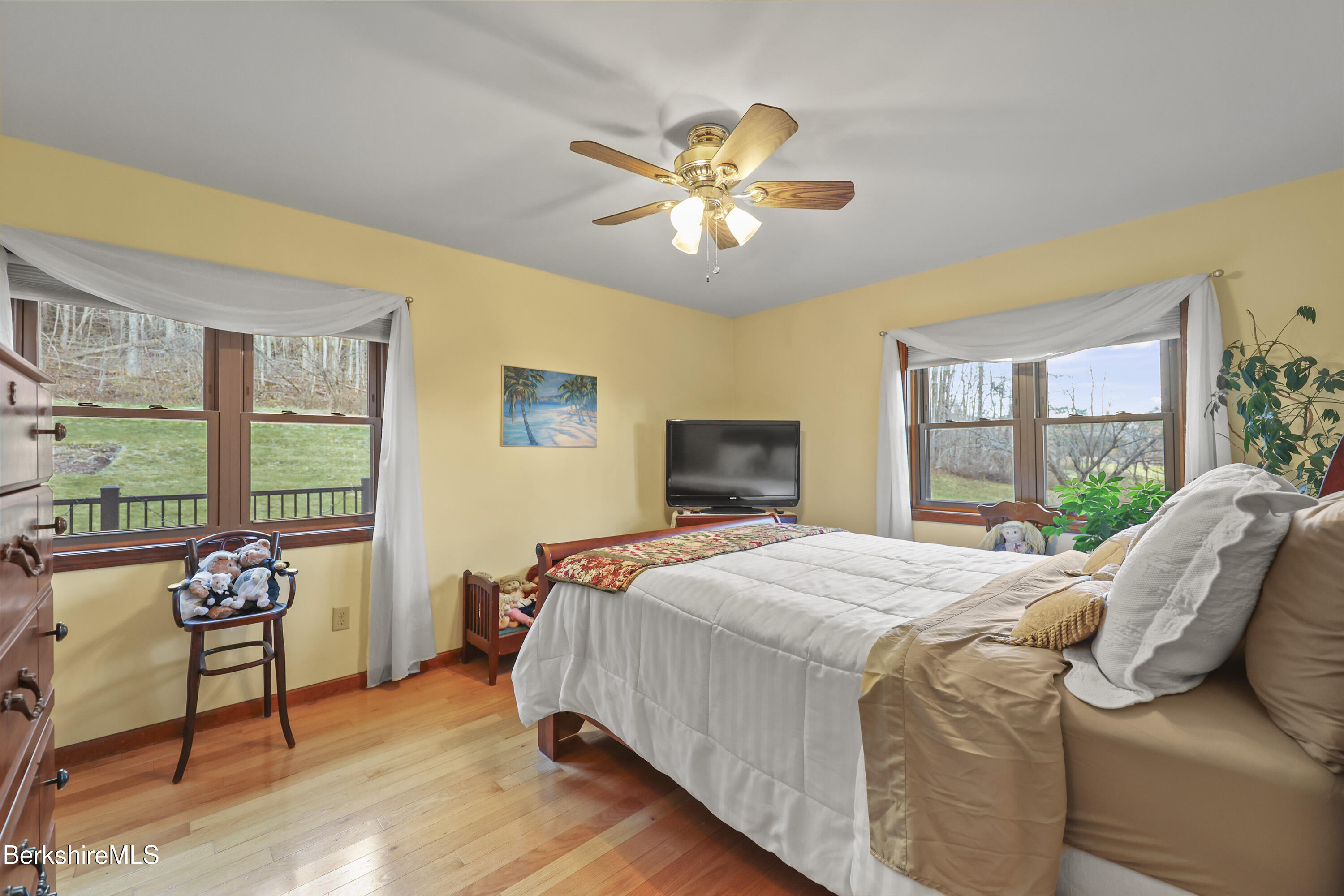 551 Tamarack Road Pittsfield, MA 01201 - Photo 21 of 51 a bedroom with a bed and a chandelier