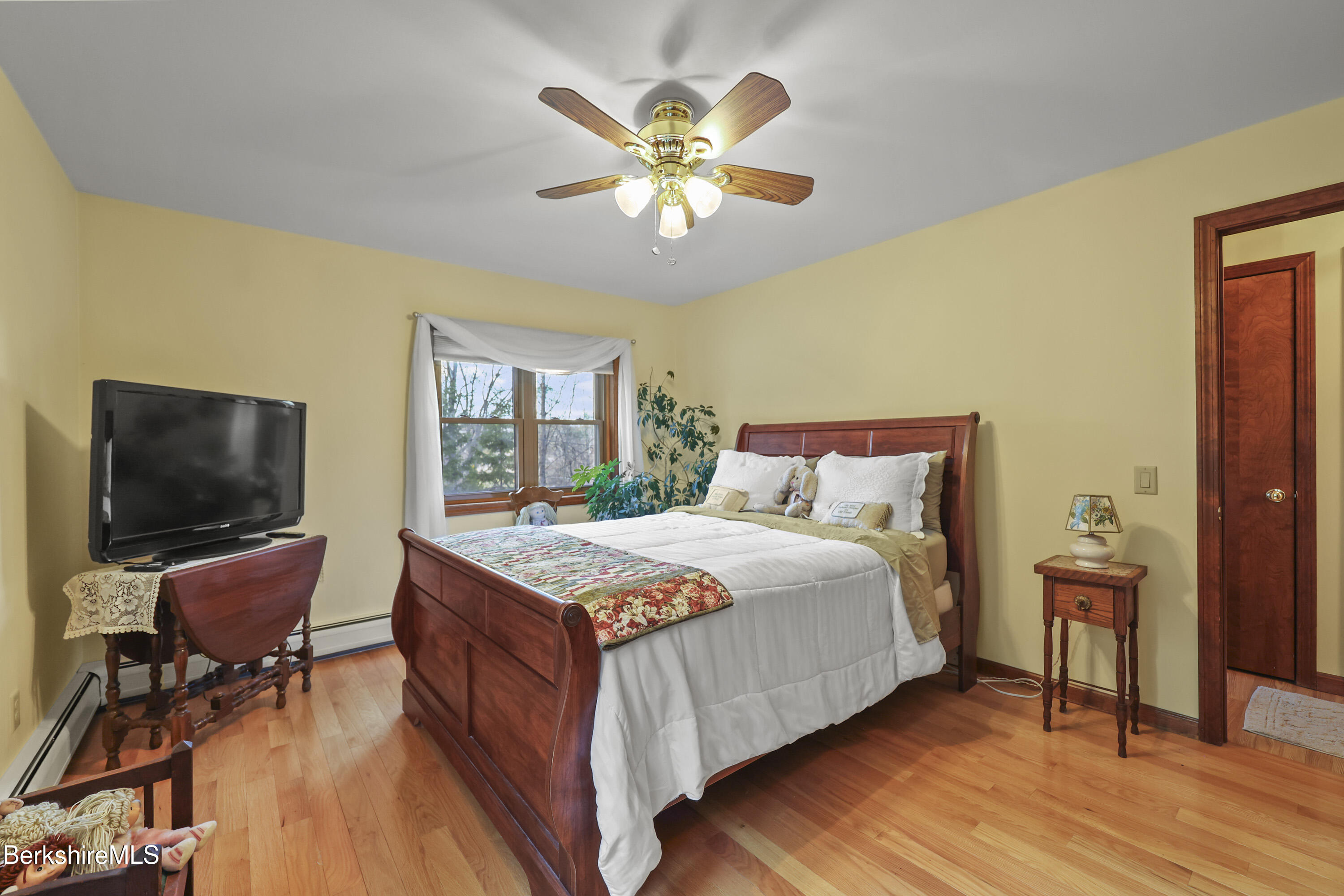 551 Tamarack Road Pittsfield, MA 01201 - Photo 22 of 51 a bedroom with a bed and wooden floor