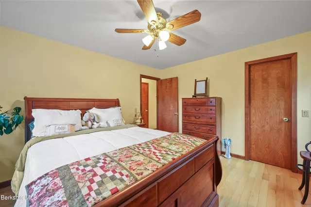 a bedroom with a large bed and a chandelier