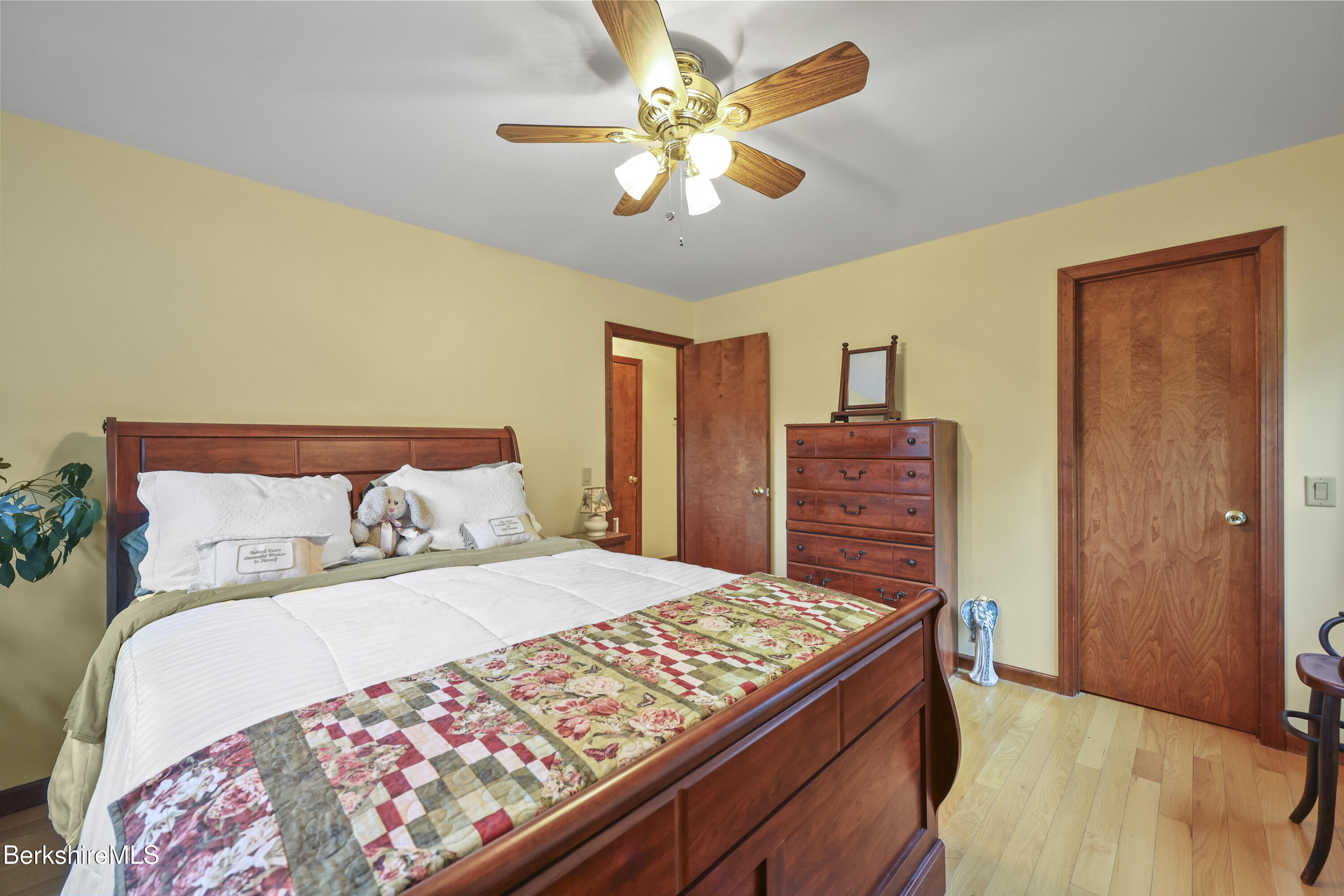 551 Tamarack Road Pittsfield, MA 01201 - Photo 23 of 51 a bedroom with a large bed and a chandelier