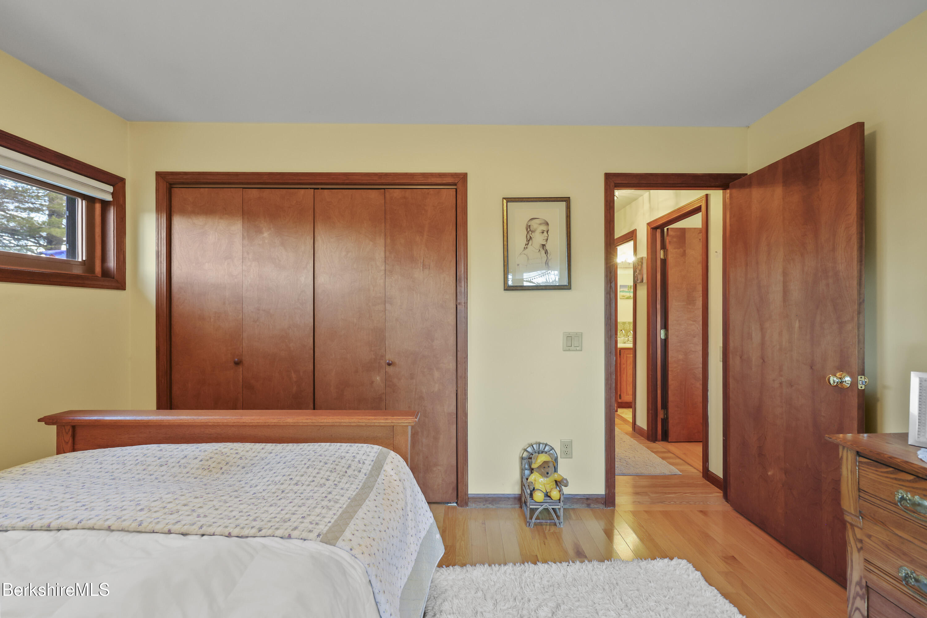 551 Tamarack Road Pittsfield, MA 01201 - Photo 25 of 51 a bedroom with a bed and wooden floor