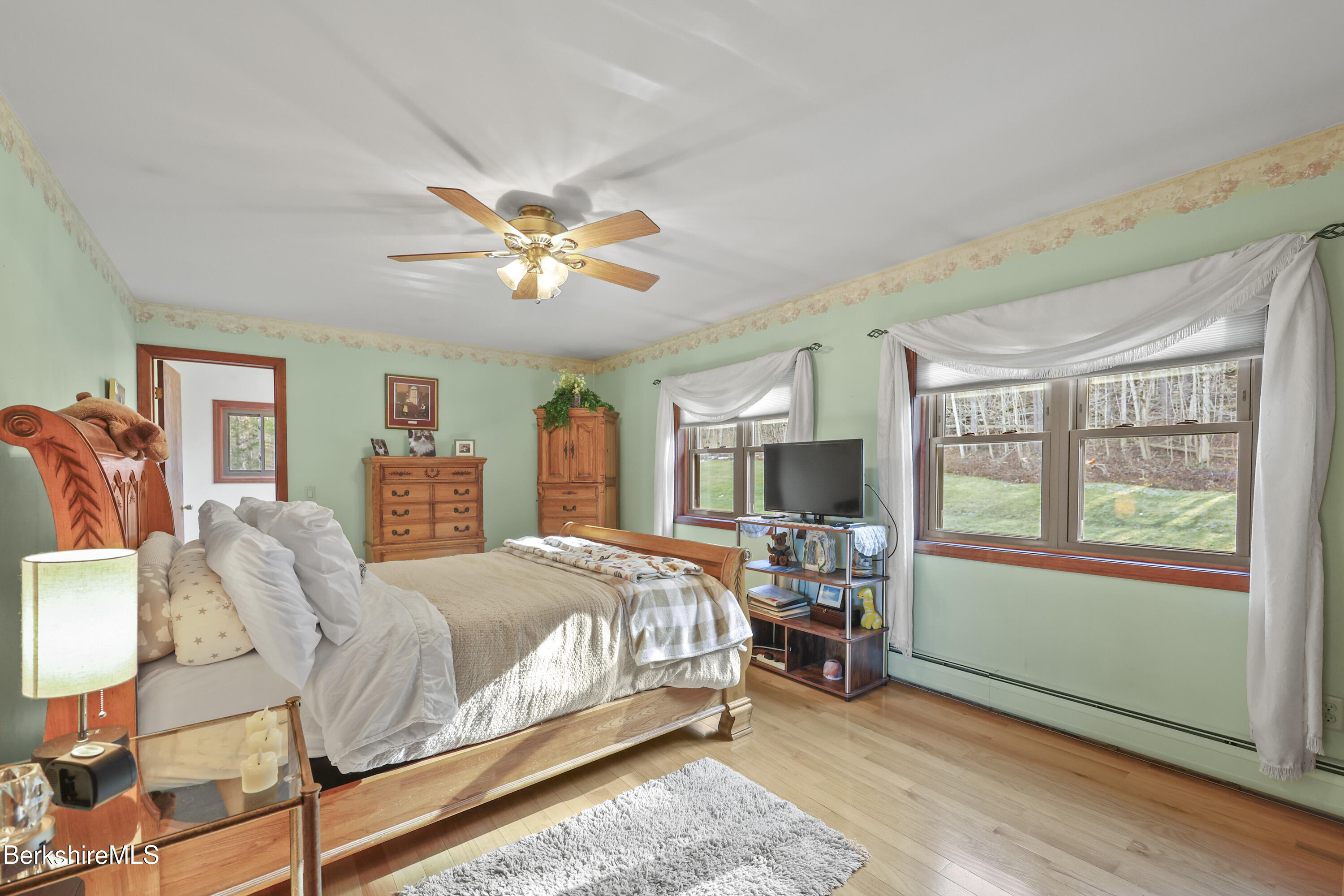 551 Tamarack Road Pittsfield, MA 01201 - Photo 27 of 51 a bedroom with a bed and a chandelier