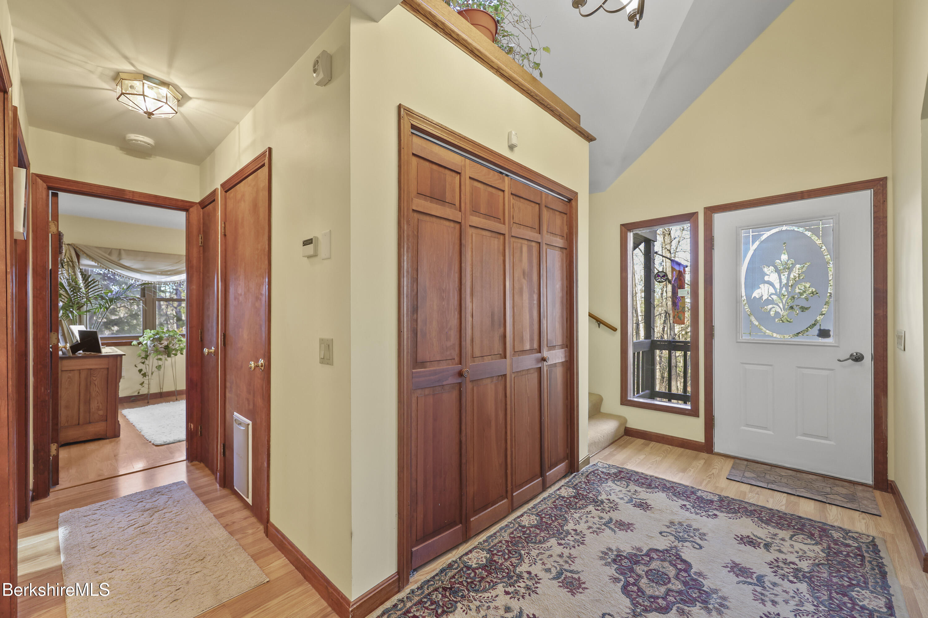 551 Tamarack Road Pittsfield, MA 01201 - Photo 3 of 51 a view of a hallway with wooden floor and windows