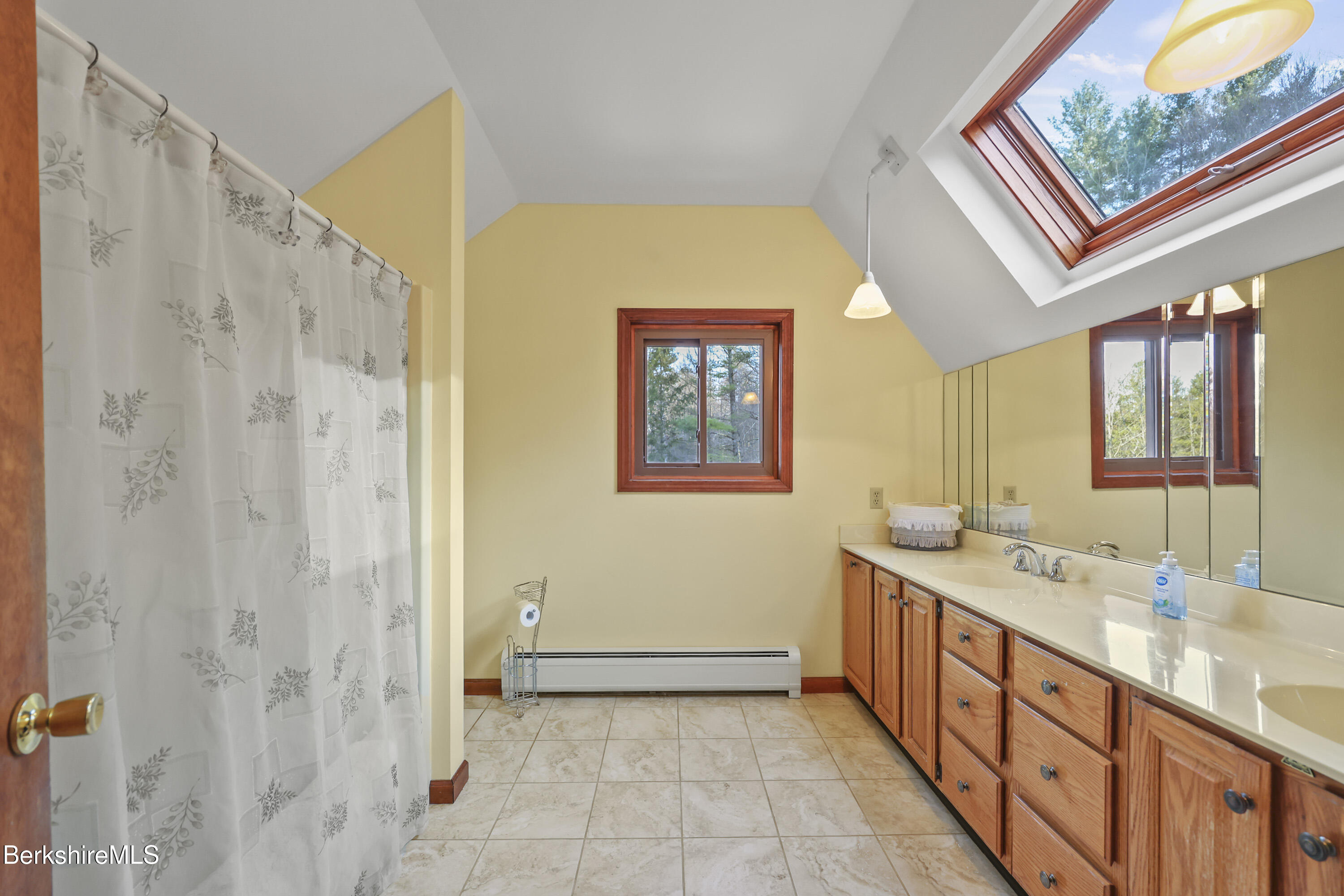 551 Tamarack Road Pittsfield, MA 01201 - Photo 31 of 51 a bathroom with a double vanity sink a mirror and a shower