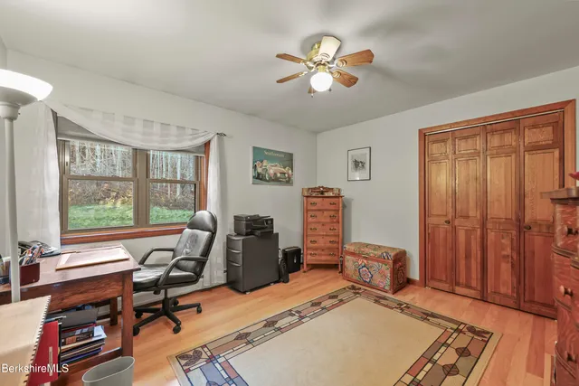 a view of a workspace with furniture and a window