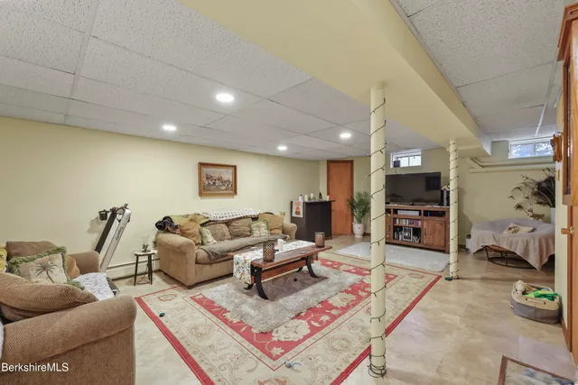 a bedroom with furniture and a flat screen tv