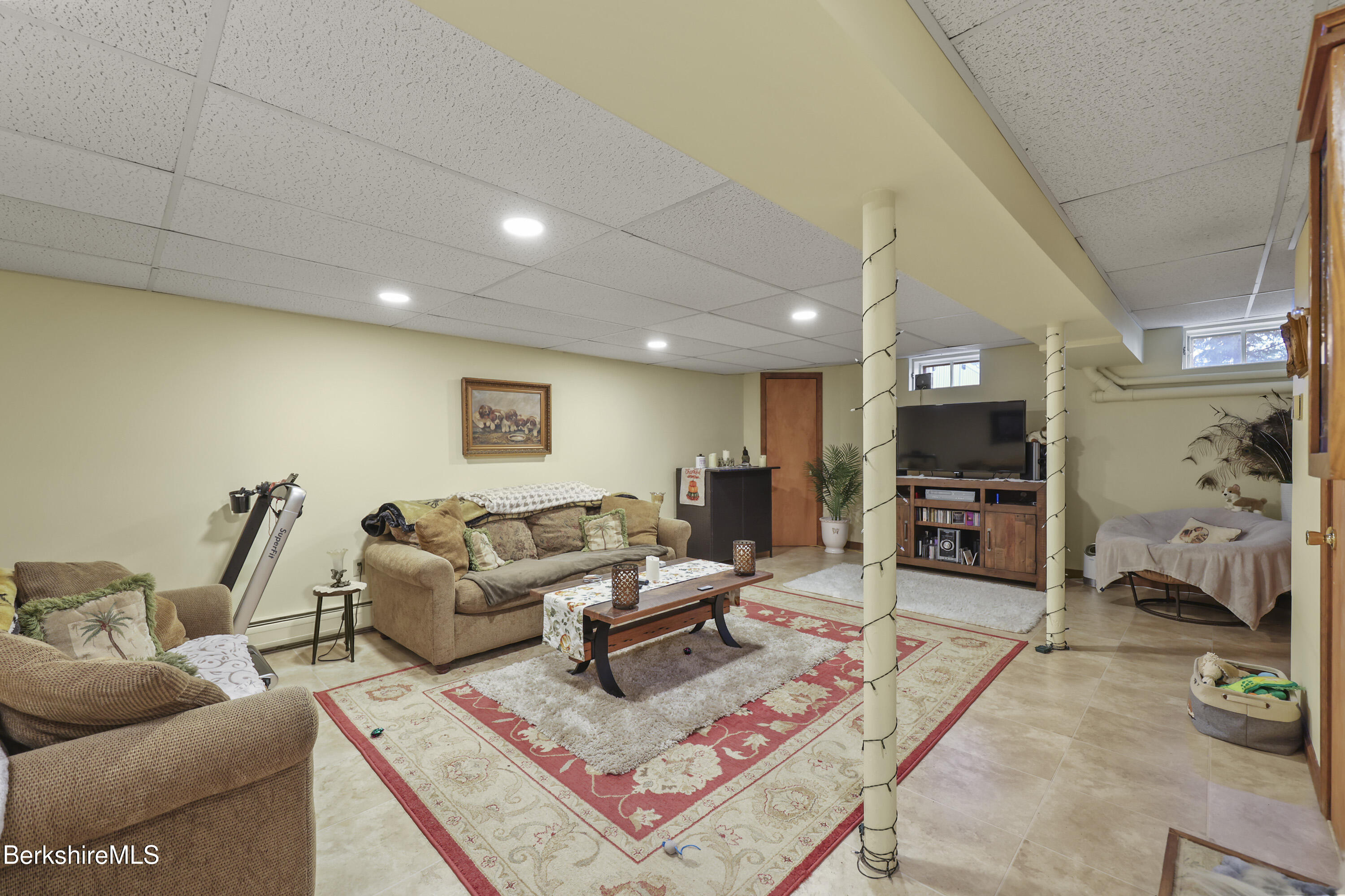 551 Tamarack Road Pittsfield, MA 01201 - Photo 34 of 51 a living room with furniture a flat screen tv and a fireplace