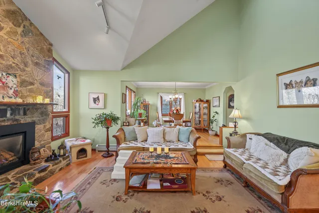 a living room with furniture a fireplace and a large window