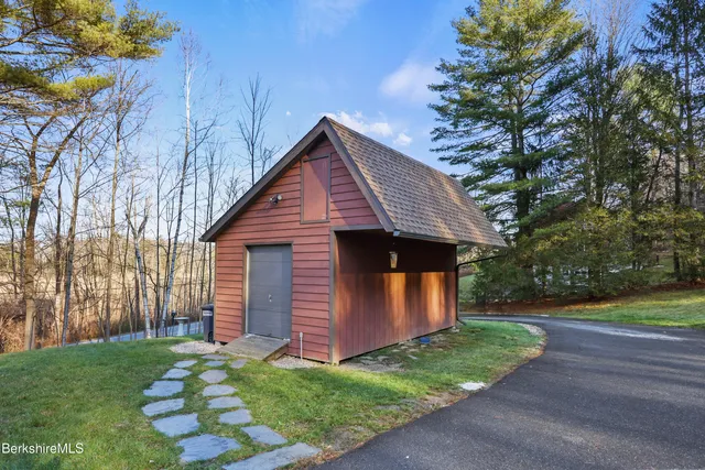 a view of a house with a big yard and large trees