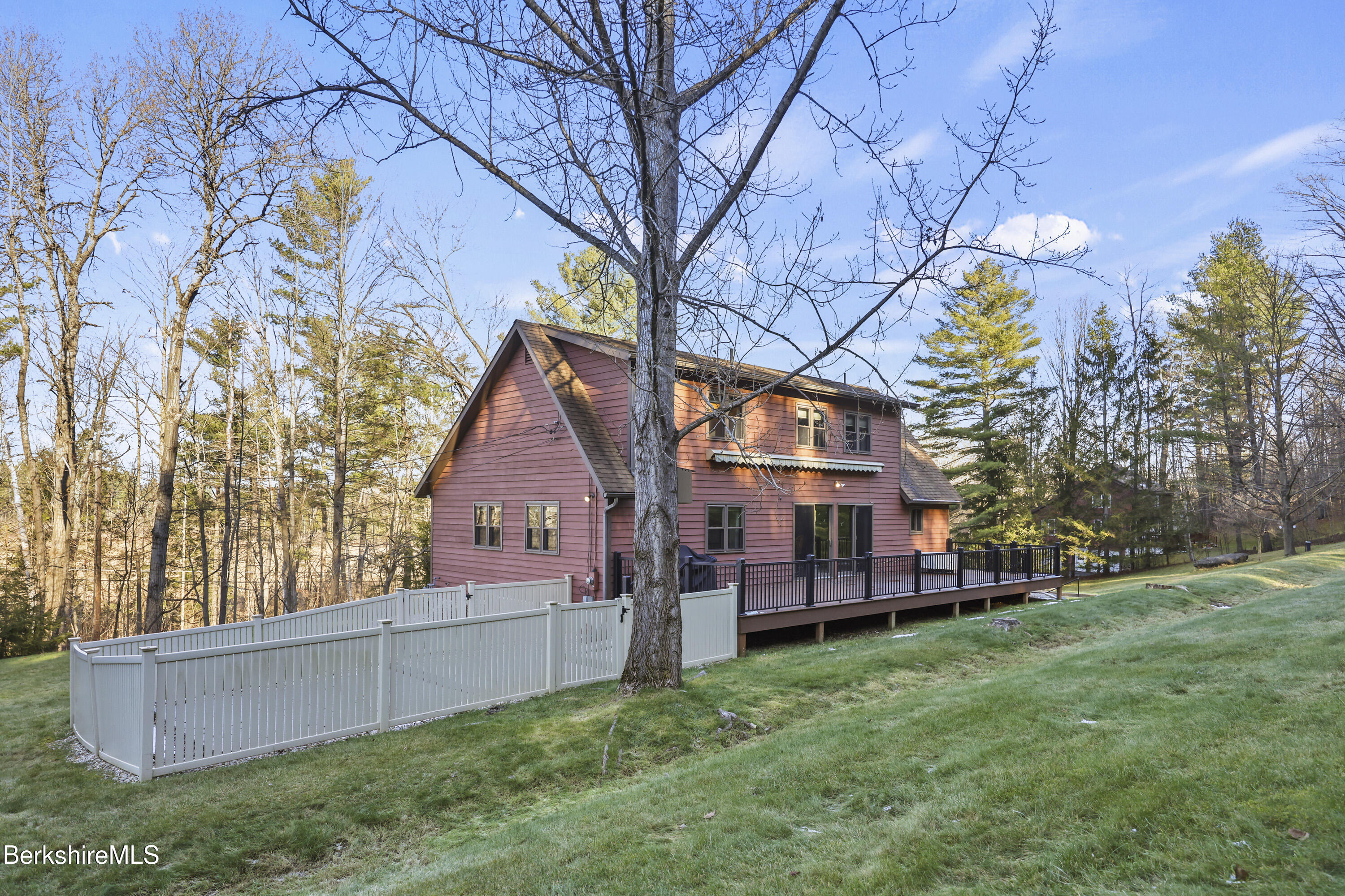 551 Tamarack Road Pittsfield, MA 01201 - Photo 46 of 51 a view of backyard with large tree and wooden fence