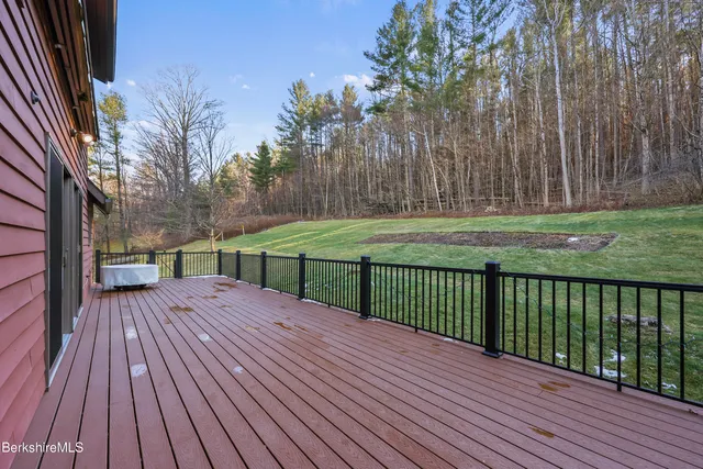 a view of a house with a wooden deck