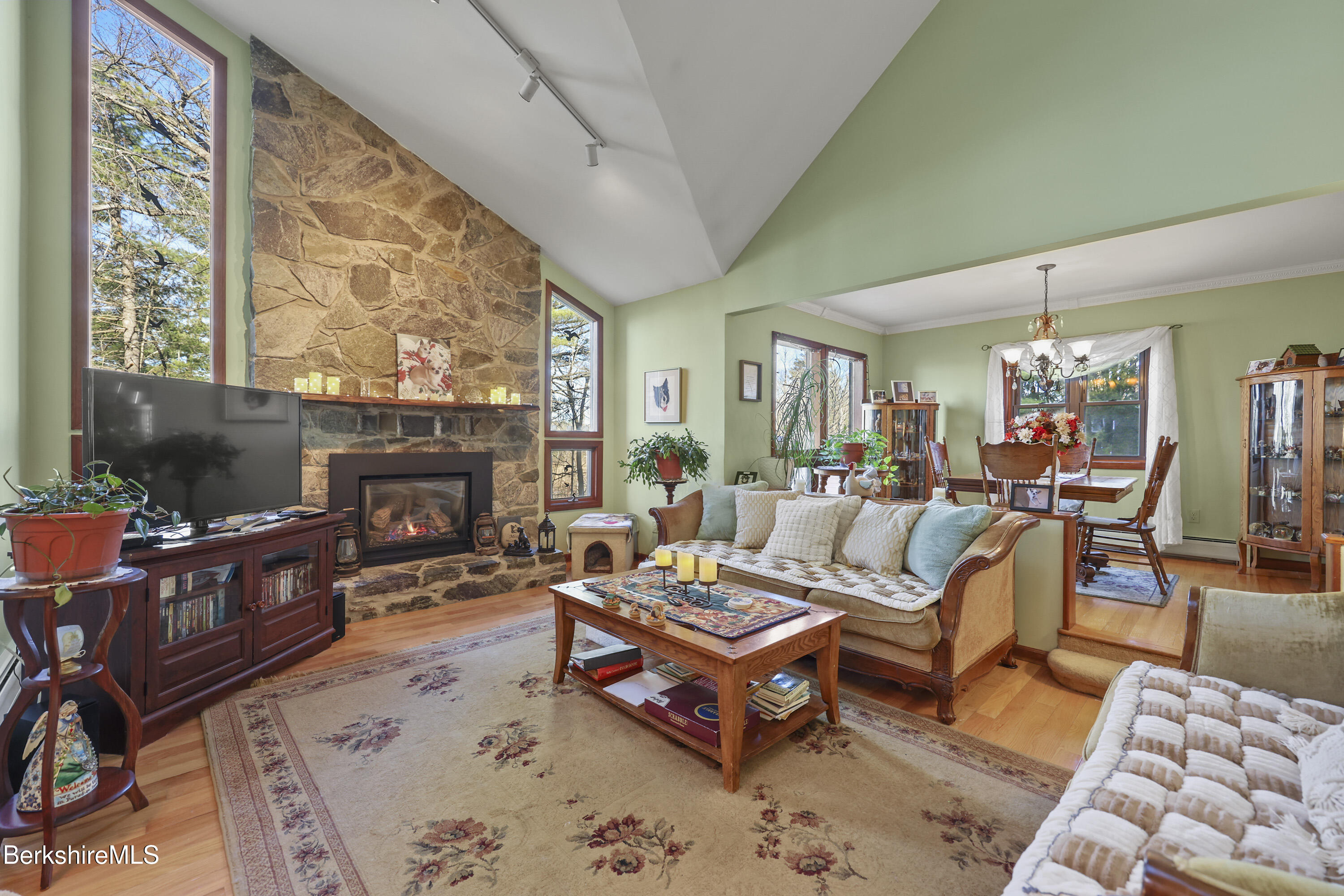 551 Tamarack Road Pittsfield, MA 01201 - Photo 5 of 51 a living room with furniture a fireplace and a large window