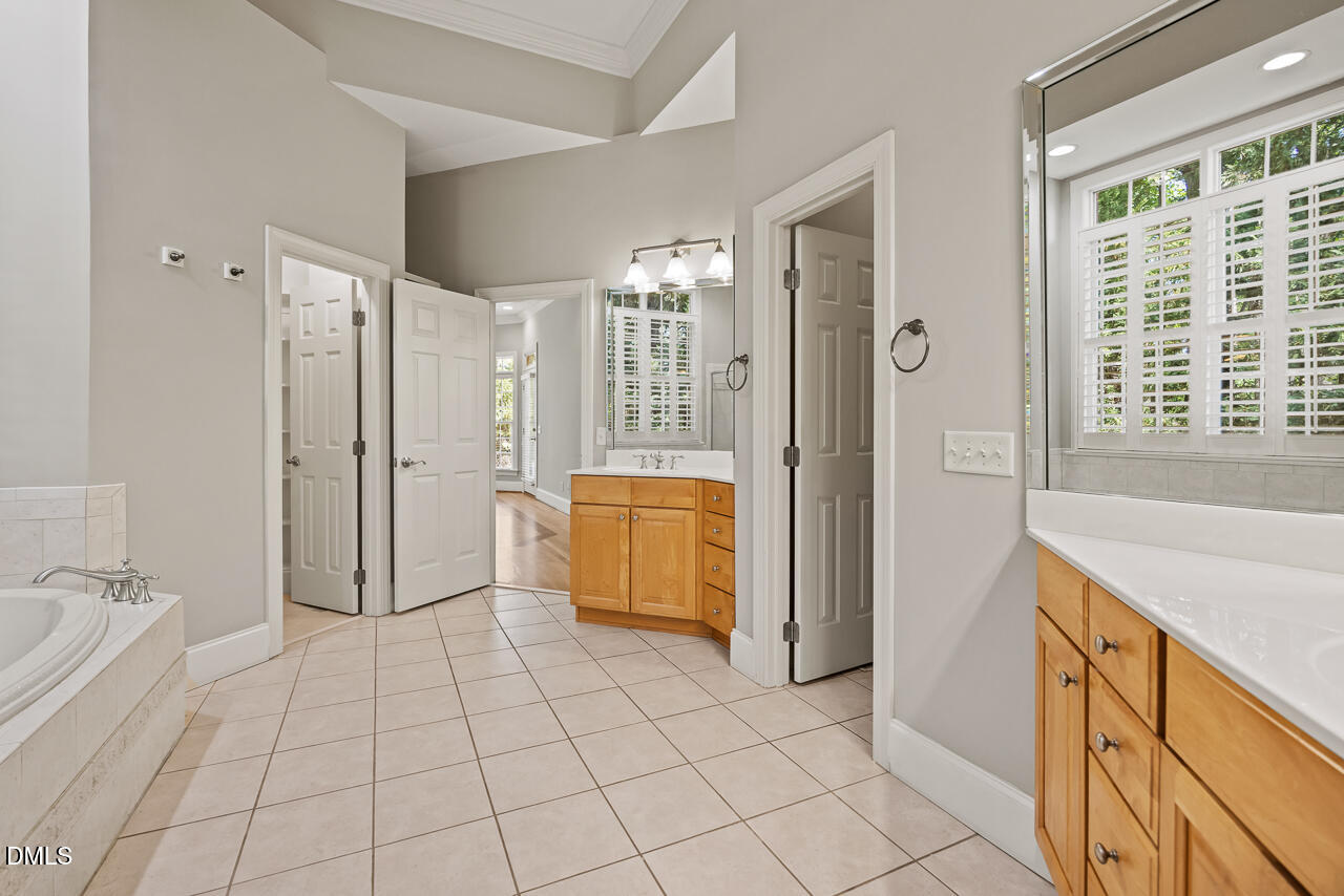 4004 Frontenac Court Apex, NC 27539 - Photo 29 of 61 a view of a bathroom with tub shower and windows