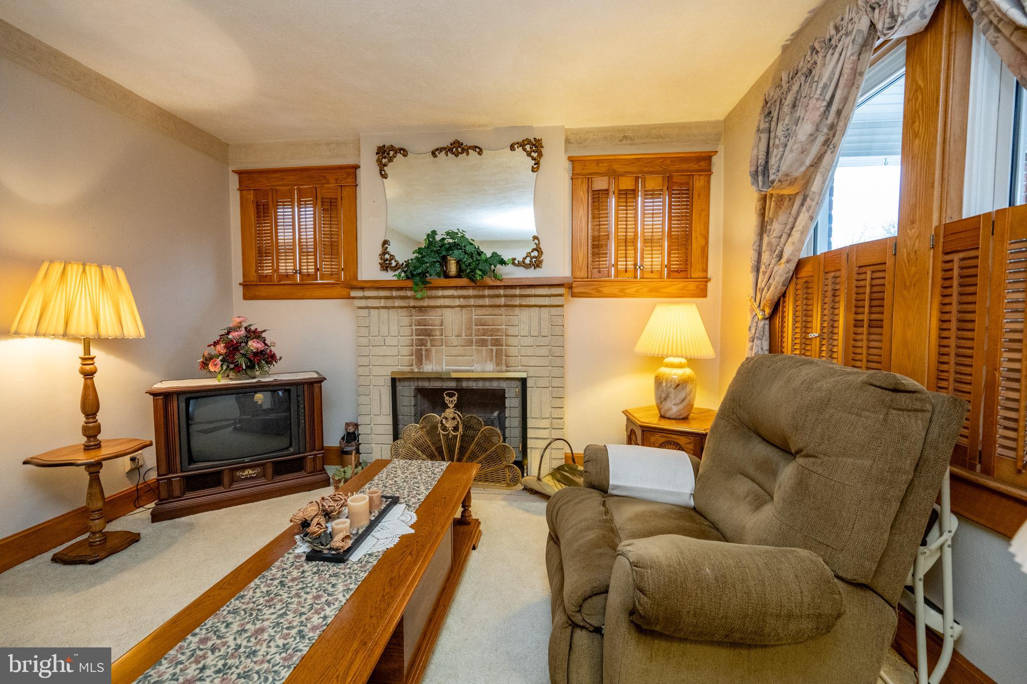 313 West Liberty Street Oakland, MD 21550 - Photo 21 of 59 a living room with furniture fireplace and a flat screen tv