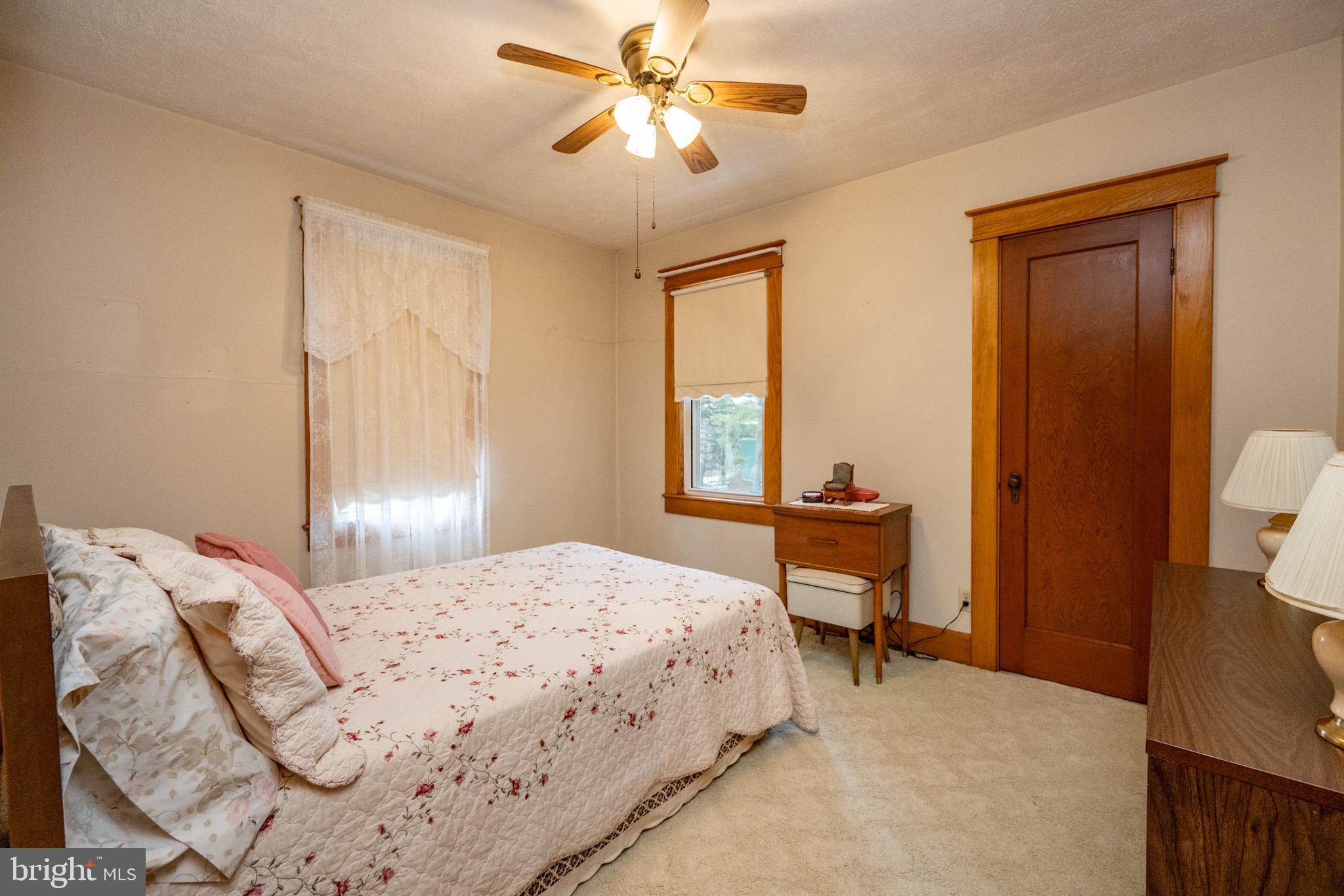 313 West Liberty Street Oakland, MD 21550 - Photo 24 of 59 a bedroom with a bed and a chandelier