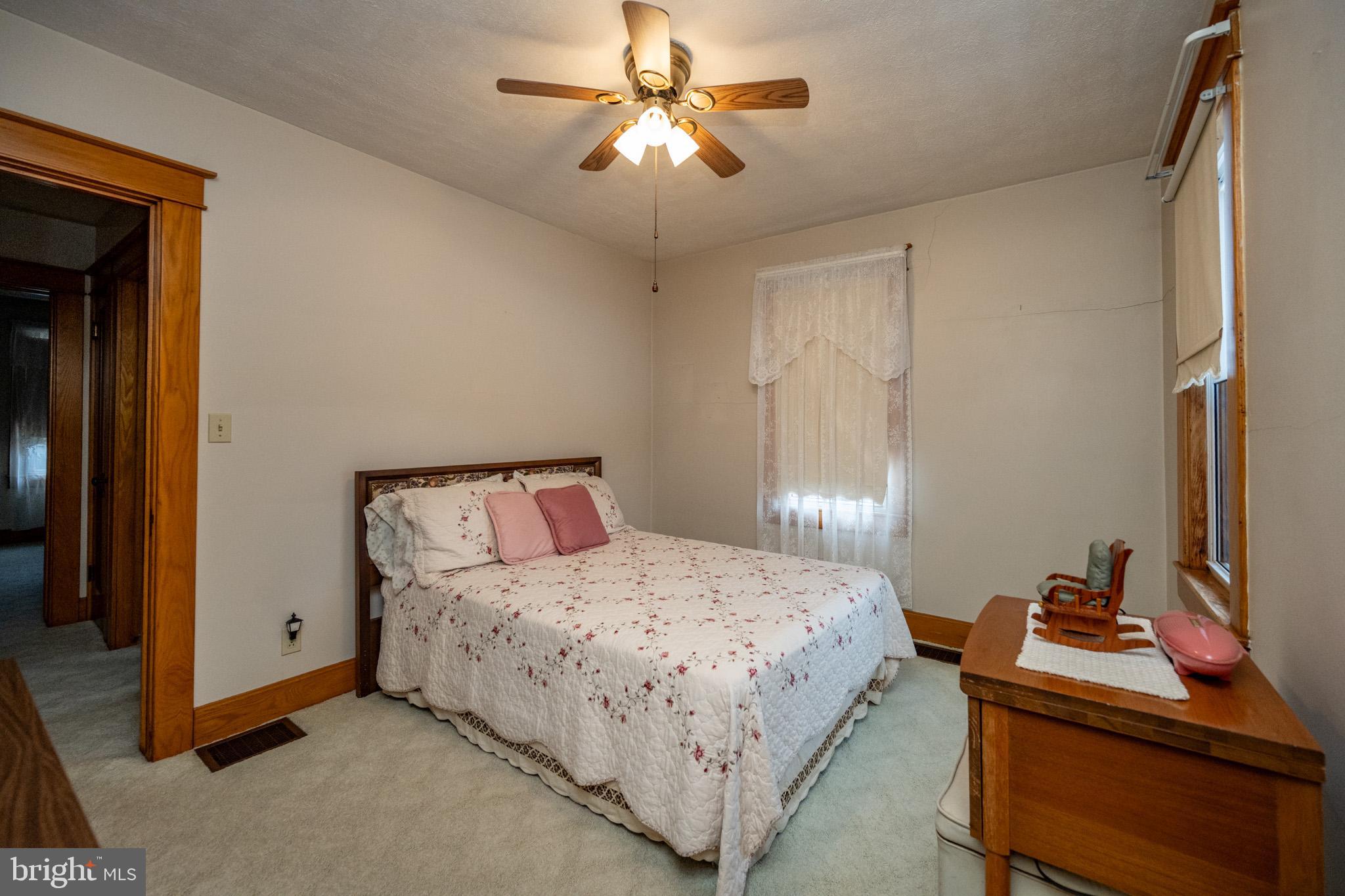313 West Liberty Street Oakland, MD 21550 - Photo 25 of 59 a bedroom with a bed and a chandelier