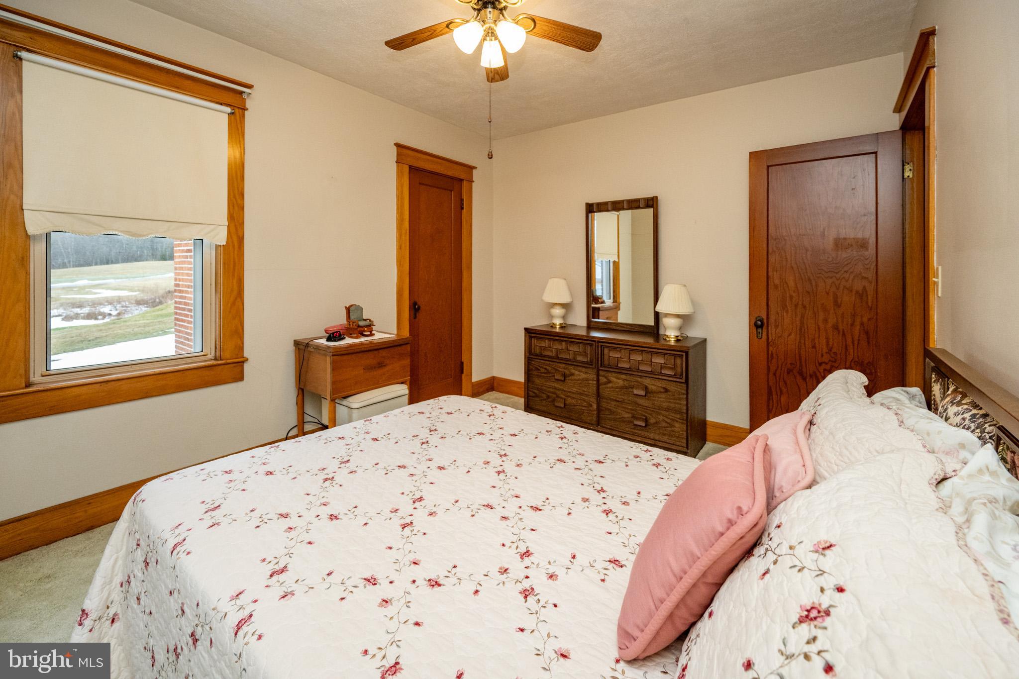 313 West Liberty Street Oakland, MD 21550 - Photo 27 of 59 a bedroom with a bed and a chandelier