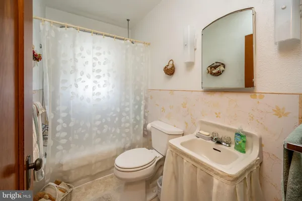 a bedroom with a bed and a flat tv screen on dresser