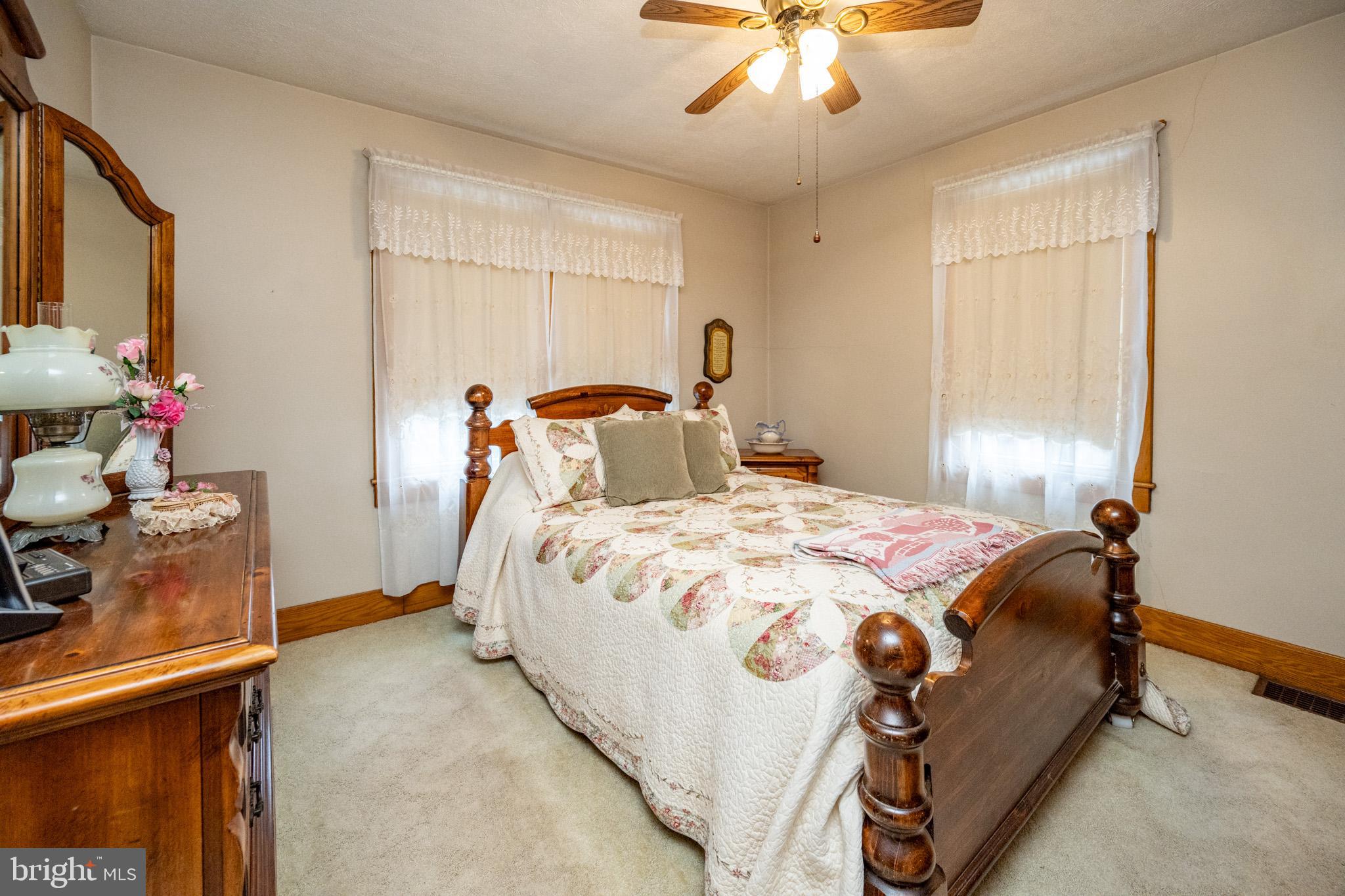 313 West Liberty Street Oakland, MD 21550 - Photo 30 of 59 a bedroom with a bed and a chandelier