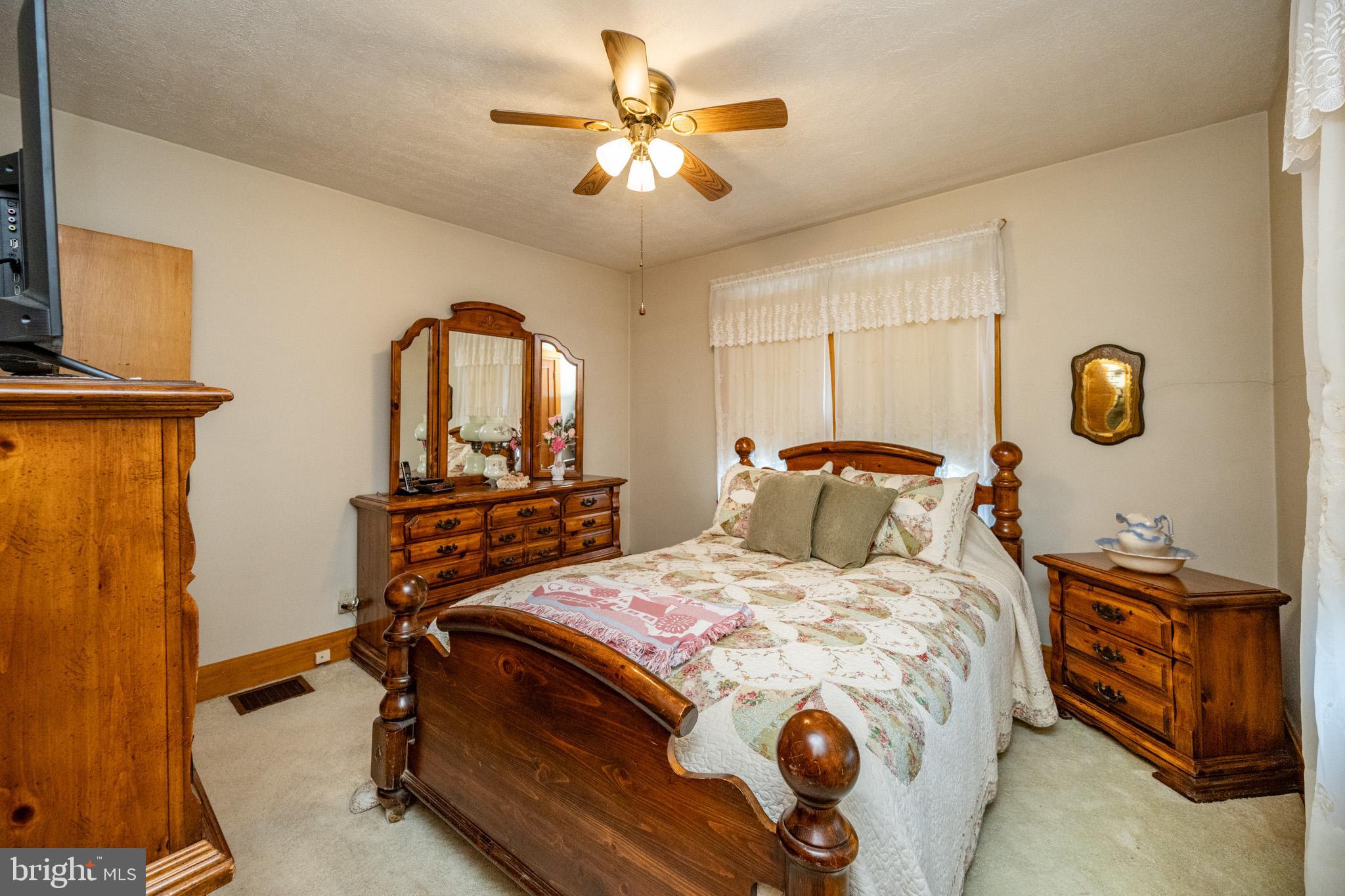 313 West Liberty Street Oakland, MD 21550 - Photo 31 of 59 a bedroom with a bed and a chandelier