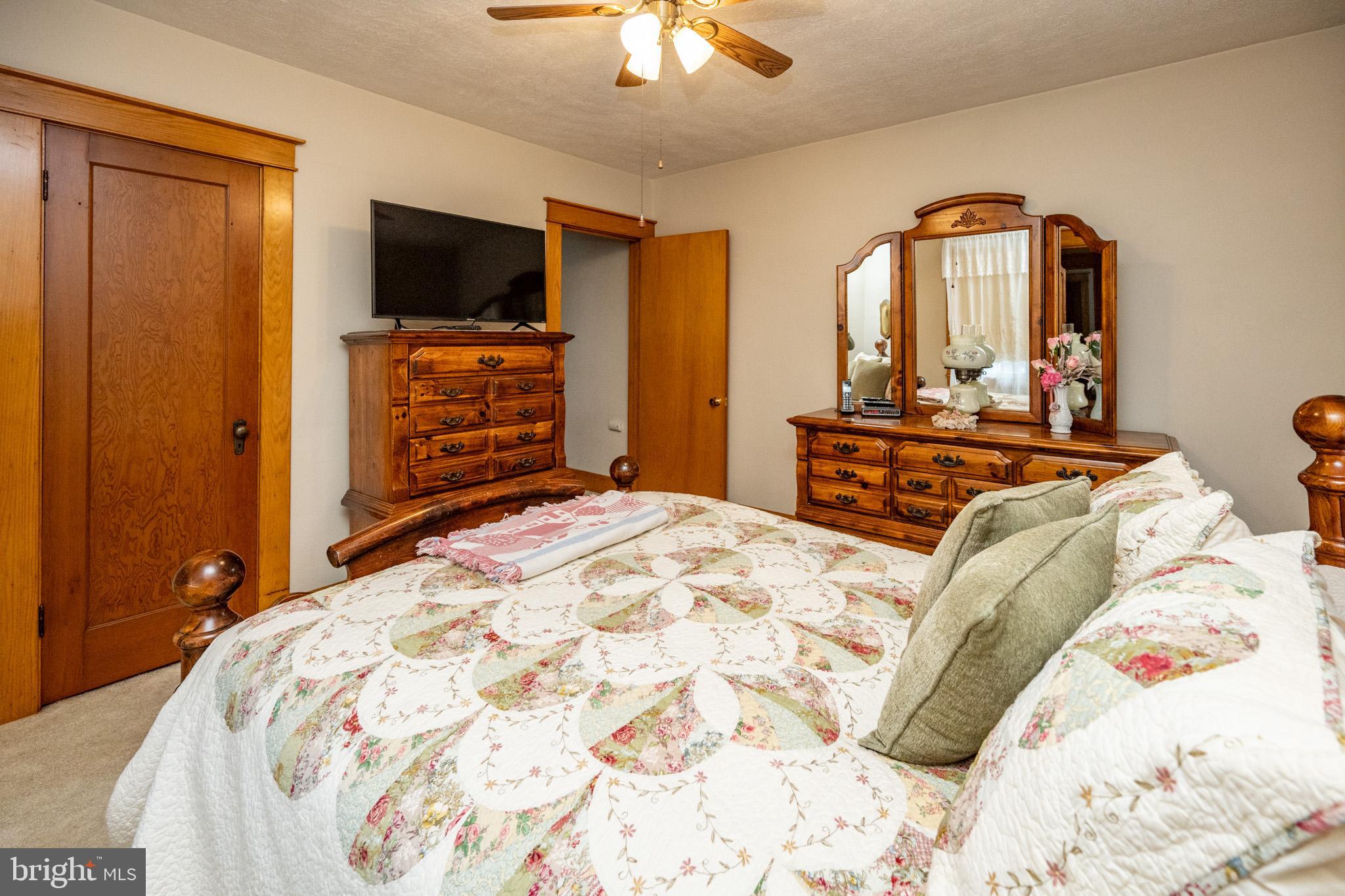 313 West Liberty Street Oakland, MD 21550 - Photo 32 of 59 a bedroom with a bed and a flat tv screen on dresser