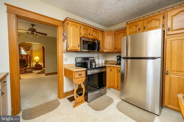 a kitchen with a table chairs sink and cabinets