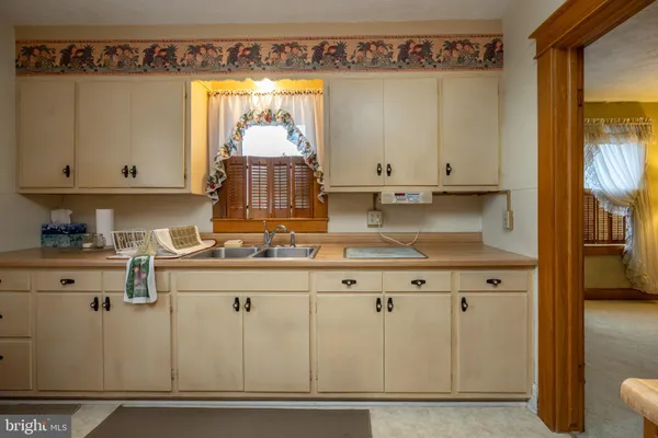 a kitchen with a table chairs refrigerator and cabinets