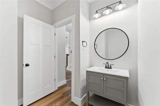 a bathroom with a sink a mirror a vanity and a toilet