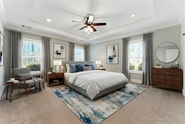 a spacious bedroom with a bed a couch and large window