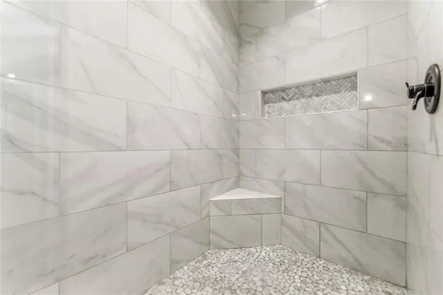 a bathroom with a white toilet and a shower