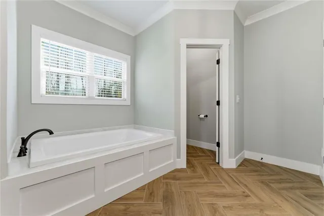 a spacious bathroom with a bathtub and a window