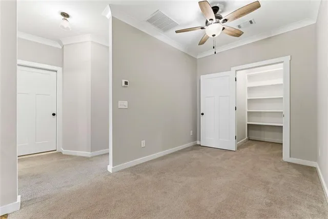 a view of an empty room with a ceiling fan