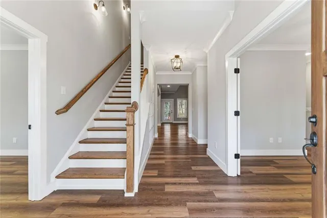 a view of entryway and hall with wooden floor