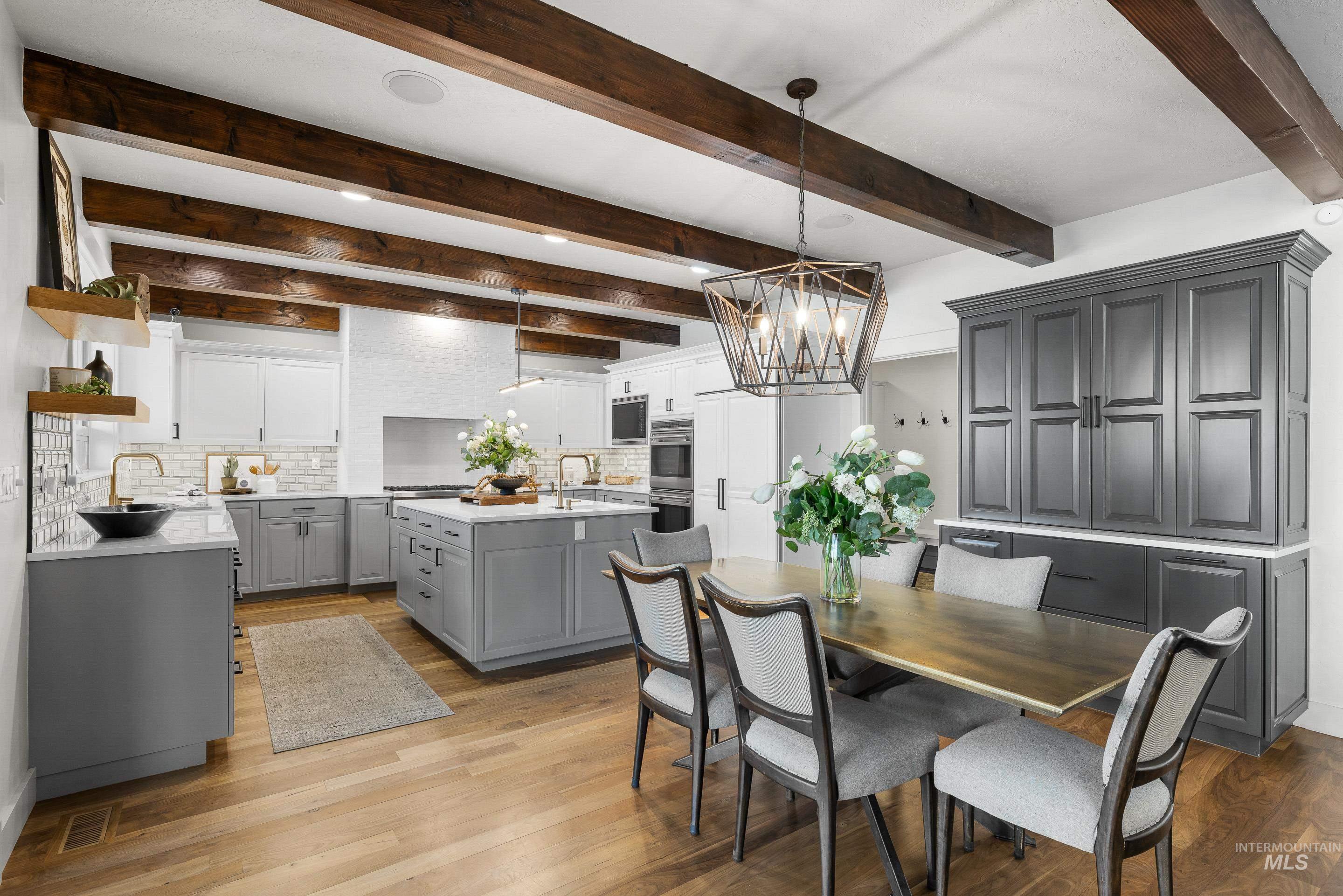 1166 East Rivers End Drive Eagle, ID 83616 - Photo 11 of 50 Dining space with light wood finished floors, hanging lights, and beamed ceiling