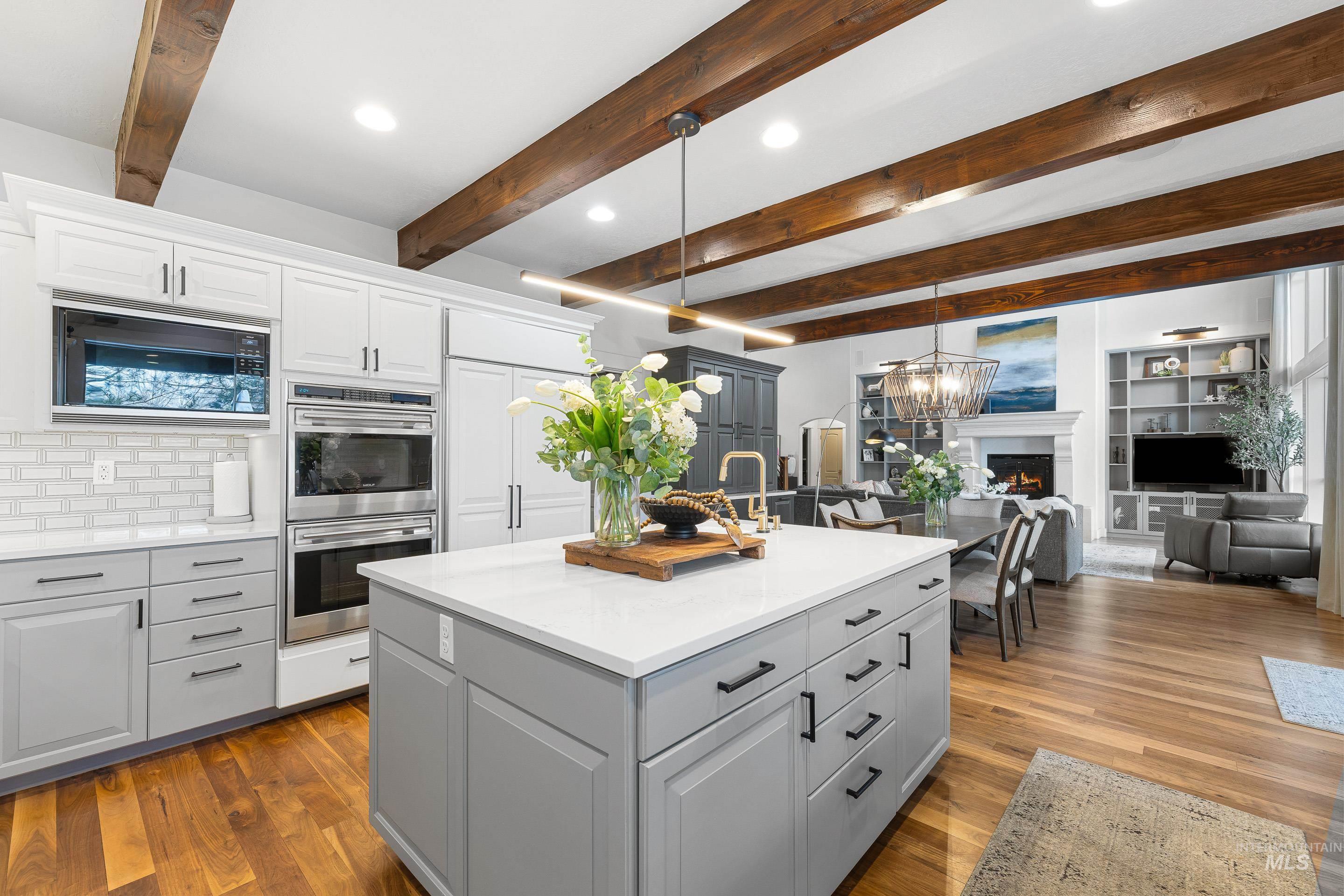 1166 East Rivers End Drive Eagle, ID 83616 - Photo 50 of 50 Kitchen featuring stainless steel double oven, open floor plan, light stone counters, built in microwave, and a kitchen island