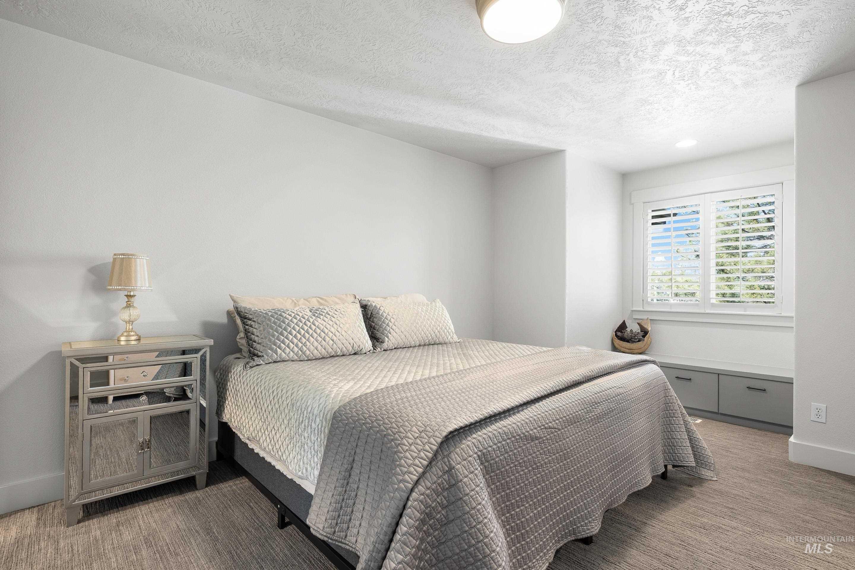 1166 East Rivers End Drive Eagle, ID 83616 - Photo 31 of 50 Bedroom with a textured ceiling and carpet flooring