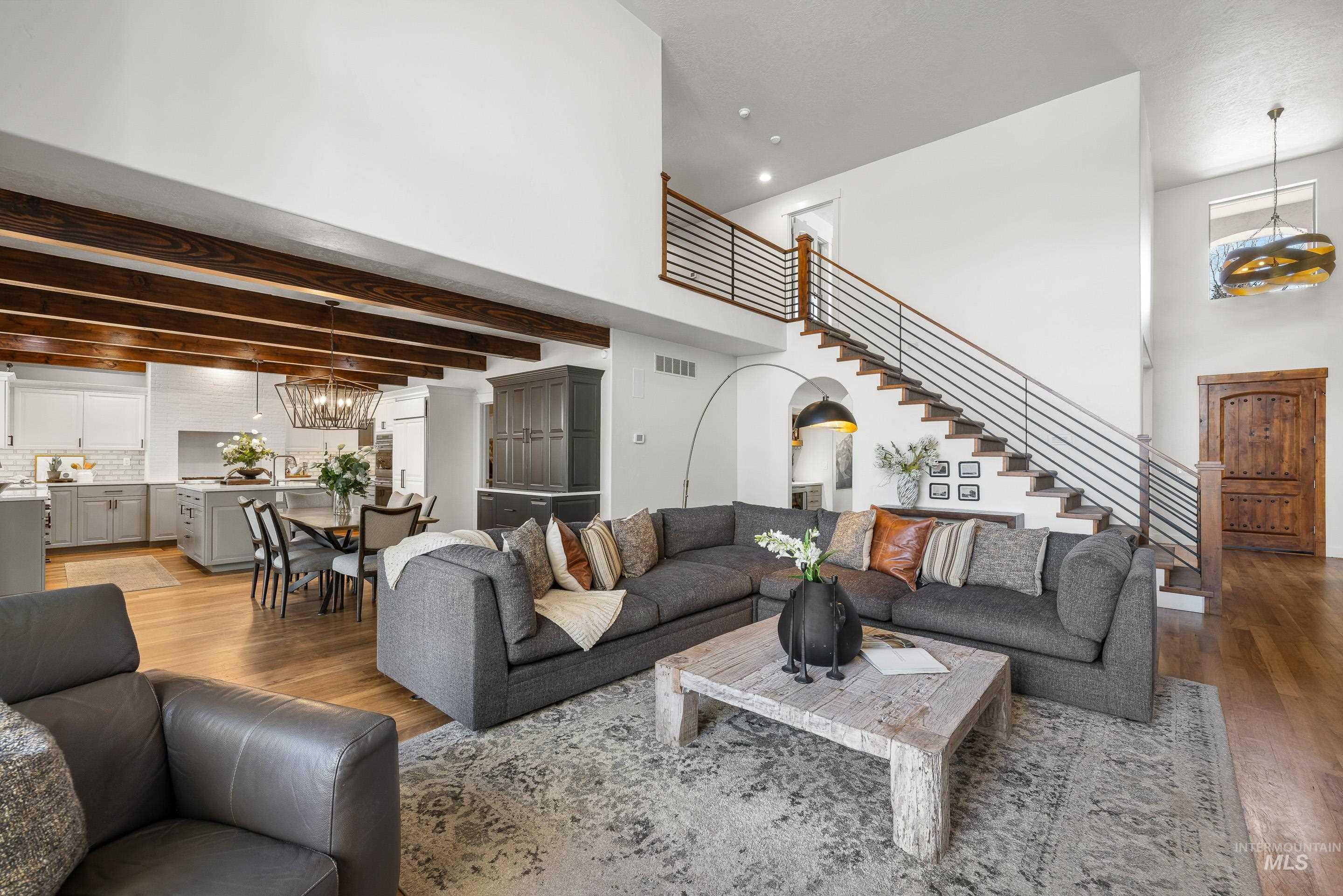 1166 East Rivers End Drive Eagle, ID 83616 - Photo 8 of 50 Living room featuring a high ceiling, suspended lighting, and wood finished floors