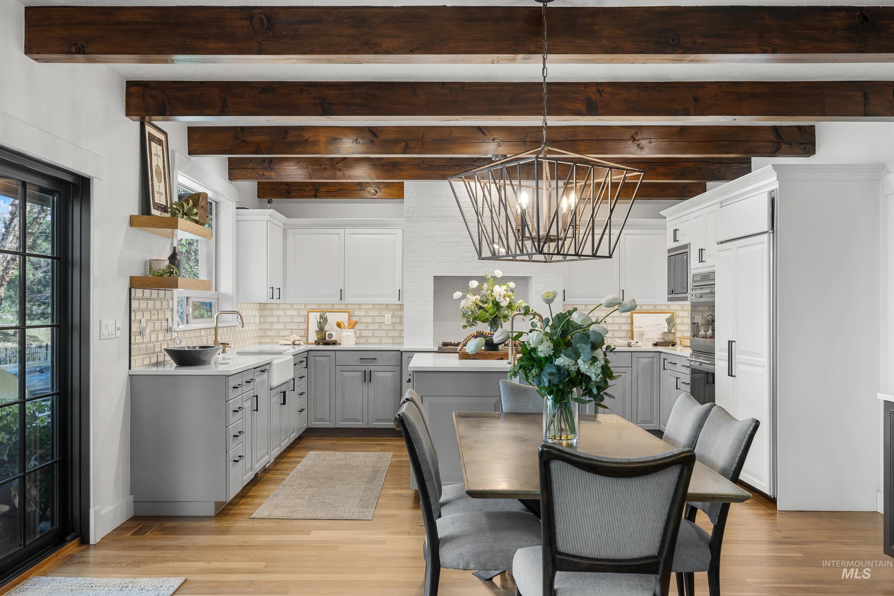 1166 East Rivers End Drive Eagle, ID 83616 - Photo 9 of 50 Dining space featuring hanging lights, beamed ceiling, and light wood-style flooring