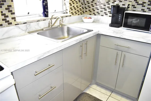 a kitchen with a sink and a stove top oven