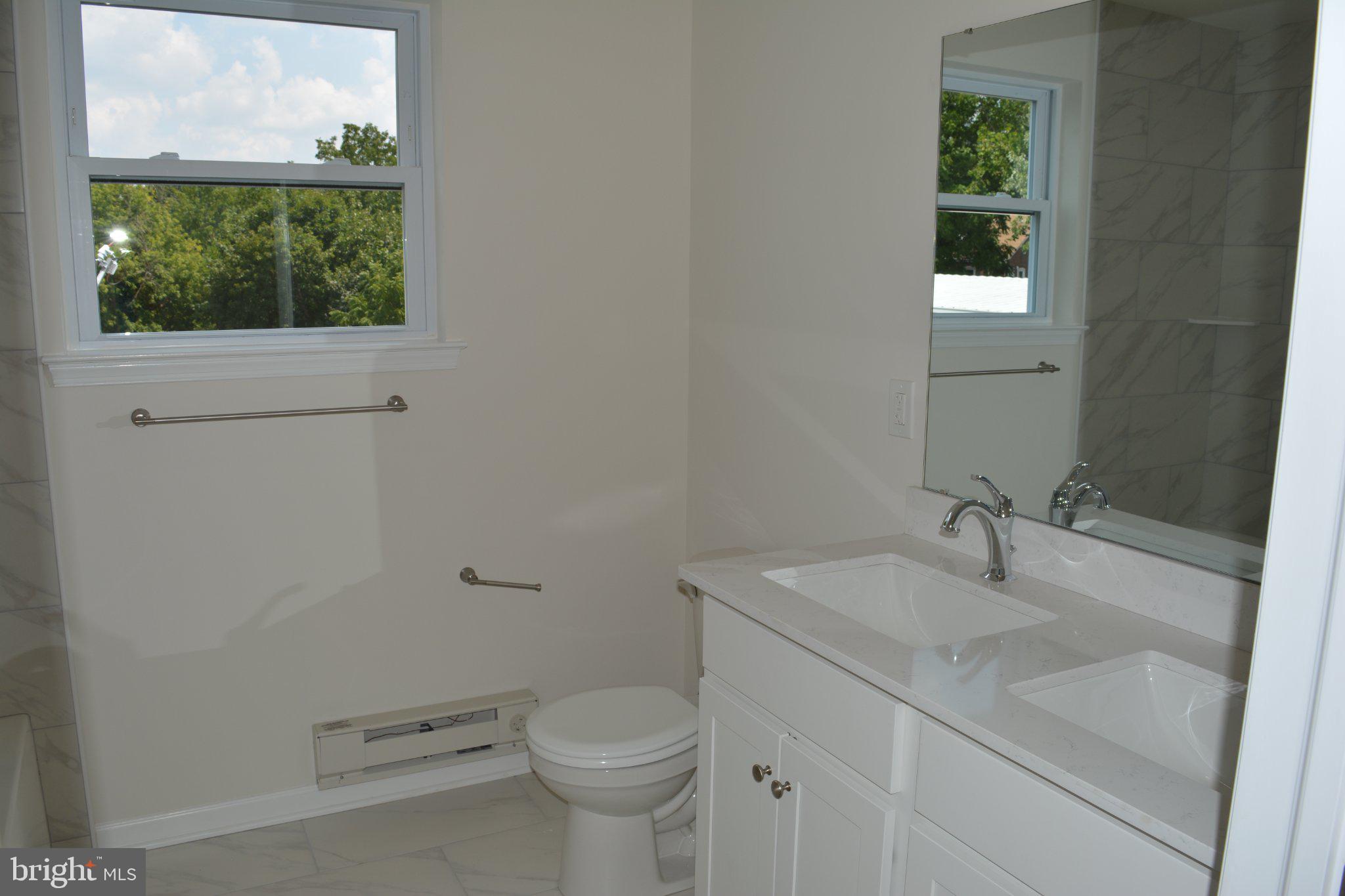 7631 Ridge Avenue, Unit 2 Philadelphia, PA 19128 - Photo 13 of 16 Bright and airy modern bathroom retreat.