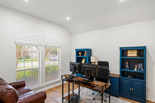 a view of a workspace with furniture and a window