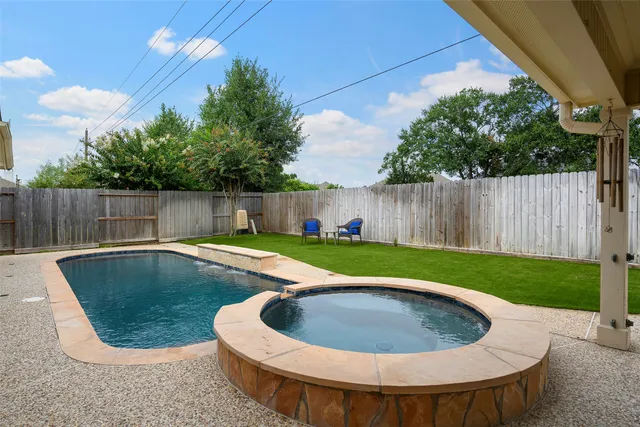 a view of a swimming pool with a backyard