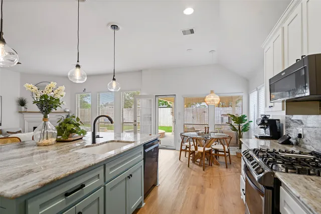a kitchen with lots of counter top space and wooden floor