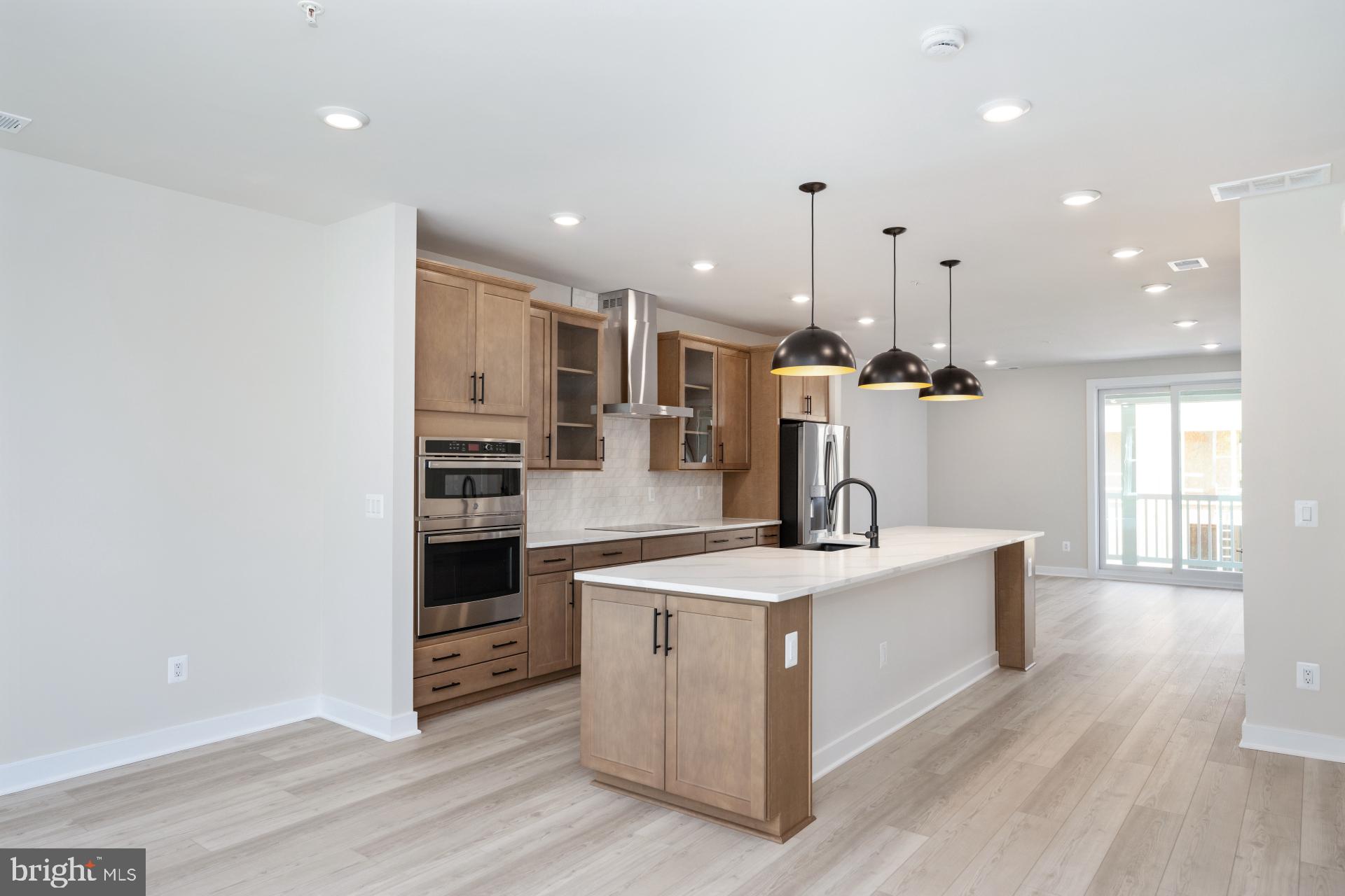 a large kitchen with a sink and a stove top oven
