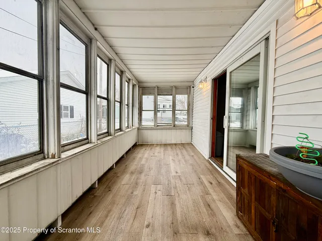 a view of an entryway with wooden floor