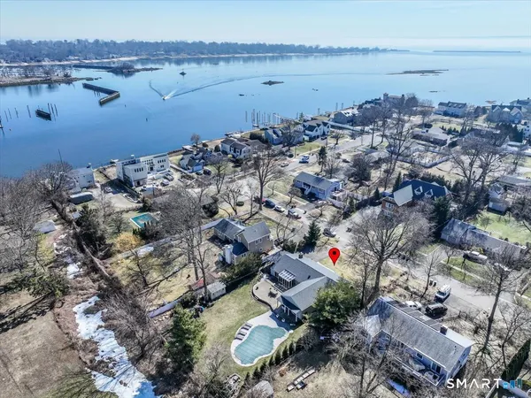 an aerial view of a houses with a lake