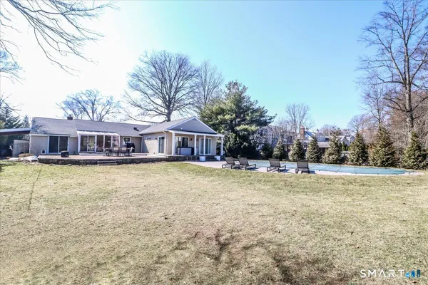 a view of a house with a yard and covered with snow