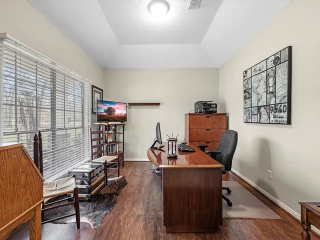 a workspace with furniture and wooden floor