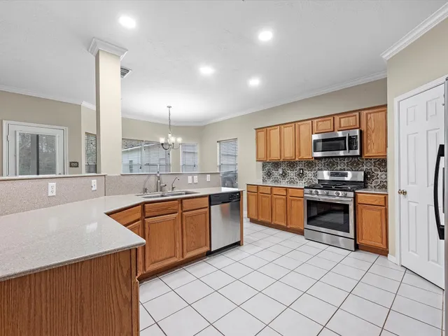a kitchen with stainless steel appliances granite countertop a stove sink and cabinets